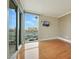 Bedroom features floor-to-ceiling windows with city views, hardwood flooring and mounted TV at 322 Karen Ave # 708, Las Vegas, NV 89109