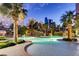 Relaxing poolside views at dusk featuring a lagoon-style pool with waterfalls at 322 Karen Ave # 708, Las Vegas, NV 89109
