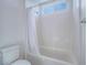 Bright bathroom featuring a shower-over-tub with white subway tile surround and a window for natural light at 3795 Canis Minor Ln # 5102, Henderson, NV 89052