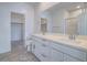 Bright bathroom features double sinks, white cabinets, and an open doorway at 3795 Canis Minor Ln # 5102, Henderson, NV 89052
