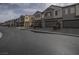 Street view of modern townhomes, each featuring two-car garages and neat landscaping at 3795 Canis Minor Ln # 5102, Henderson, NV 89052