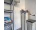 Garage interior featuring water softener and a metal storage rack at 3795 Canis Minor Ln # 5102, Henderson, NV 89052