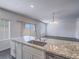 Modern kitchen with stainless steel appliances, granite countertops, and an island sink at 3795 Canis Minor Ln # 5102, Henderson, NV 89052