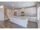 Modern kitchen with stainless steel appliances, granite countertops, and a large central island at 3795 Canis Minor Ln # 5102, Henderson, NV 89052