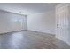 Bright living room with window and wood-look floors at 3795 Canis Minor Ln # 5102, Henderson, NV 89052