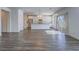 Open-concept living space featuring wood-look flooring, a kitchen with white cabinets, and stainless steel appliances at 3795 Canis Minor Ln # 5102, Henderson, NV 89052