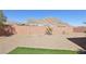 Desert landscaping features prominently in this backyard with artificial turf accents at 4001 Turquoise Falls St, Las Vegas, NV 89129