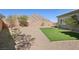 Spacious backyard featuring low-maintenance desert landscaping and artificial turf, with mountain views at 4001 Turquoise Falls St, Las Vegas, NV 89129