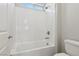 Close-up of white tiled shower with overhead shower head in bright bathroom at 4001 Turquoise Falls St, Las Vegas, NV 89129