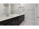 Bathroom with double sink vanity, decorative mirrors, and tiled floors at 4001 Turquoise Falls St, Las Vegas, NV 89129