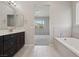 Bathroom with tub, walk-in shower, and dual sinks leading to the primary bedroom at 4001 Turquoise Falls St, Las Vegas, NV 89129