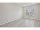Bright bedroom with two windows and wood-style tile flooring at 4001 Turquoise Falls St, Las Vegas, NV 89129