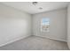 Bedroom with neutral walls, carpet, window, base molding, and an electrical outlet at 4001 Turquoise Falls St, Las Vegas, NV 89129