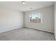 Bedroom with plush carpet and a view of the outdoors through a window at 4001 Turquoise Falls St, Las Vegas, NV 89129
