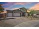 Exterior of a two-story home featuring a three-car garage and desert landscaping at 4001 Turquoise Falls St, Las Vegas, NV 89129