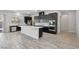 Modern kitchen featuring stainless steel appliances, dark wood cabinets and an island with white countertops at 4001 Turquoise Falls St, Las Vegas, NV 89129