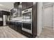 Modern kitchen with double oven, stainless steel appliances, and dark wood cabinetry at 4001 Turquoise Falls St, Las Vegas, NV 89129