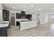 Spacious kitchen boasts a large island, stainless appliances, dark cabinets and recessed lighting at 4001 Turquoise Falls St, Las Vegas, NV 89129