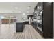 Open concept kitchen with stainless steel appliances, island with white countertops and outdoor access at 4001 Turquoise Falls St, Las Vegas, NV 89129