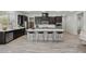 Modern kitchen boasts stainless appliances, dark wood cabinets, and quartz countertops with barstool seating at 4001 Turquoise Falls St, Las Vegas, NV 89129