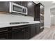 Kitchen area features stainless steel oven and cooktop, dark cabinets and white countertops at 4001 Turquoise Falls St, Las Vegas, NV 89129