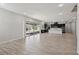 Open concept room featuring wood-style floors, sliding glass doors, and an adjacent kitchen at 4001 Turquoise Falls St, Las Vegas, NV 89129