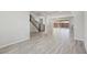 Bright living room showcasing modern wood-look tile flooring and stairway with iron railing at 4001 Turquoise Falls St, Las Vegas, NV 89129