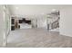 Expansive living room with wood-look tile flooring, open to the kitchen and staircase at 4001 Turquoise Falls St, Las Vegas, NV 89129