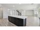 Open floor plan with kitchen island, staircase and neutral paint, offering a modern and airy feel at 4001 Turquoise Falls St, Las Vegas, NV 89129