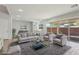 Comfortable living room with a couch, two chairs, a glass table, and sliding doors to the backyard at 4001 Turquoise Falls St, Las Vegas, NV 89129