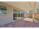 Covered patio with brick pavers and access to the home through a large sliding door at 4001 Turquoise Falls St, Las Vegas, NV 89129