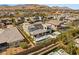 Aerial view of a home with a pristine pool, covered patio, and solar panels in a lush community at 4208 Lapis Ridge Ct, Las Vegas, NV 89135