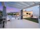 Stunning backyard showcasing a pool, outdoor kitchen, fire pit, and seamless transition to indoor living via sliding glass doors at 4208 Lapis Ridge Ct, Las Vegas, NV 89135