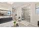 Bright bathroom featuring a soaking tub, dual sink vanity, and walk-in shower with marble surround at 4208 Lapis Ridge Ct, Las Vegas, NV 89135