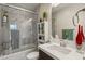 Well-lit bathroom with marble tile, glass shower doors, and decorative accents creating a spa-like ambiance at 4208 Lapis Ridge Ct, Las Vegas, NV 89135
