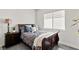 Bedroom with wood floors, full-sized bed, and window with blinds at 4208 Lapis Ridge Ct, Las Vegas, NV 89135