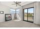 Bright bedroom with large windows, plush carpet, and a private balcony offering scenic views at 4208 Lapis Ridge Ct, Las Vegas, NV 89135