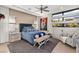 Primary bedroom with accent wall, sitting area, and expansive windows at 4208 Lapis Ridge Ct, Las Vegas, NV 89135