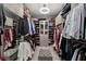 Walk-in closet with custom shelving, mirrored walls, and center ottoman at 4208 Lapis Ridge Ct, Las Vegas, NV 89135