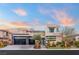 Contemporary two-story home boasts a sleek design with a glass garage door and desert landscaping at 4208 Lapis Ridge Ct, Las Vegas, NV 89135