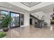 Bright foyer featuring tiled floors, open staircase, and modern design elements for a welcoming entrance at 4208 Lapis Ridge Ct, Las Vegas, NV 89135