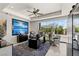 Modern home office with sleek black desk, seating, art and patio view for a bright and inspiring workspace at 4208 Lapis Ridge Ct, Las Vegas, NV 89135