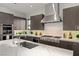 Modern kitchen features stainless steel appliances, custom cabinets, and a marble backsplash at 4208 Lapis Ridge Ct, Las Vegas, NV 89135