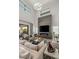 Comfortable living room with a sleek fireplace, large windows, and stylish decor at 4208 Lapis Ridge Ct, Las Vegas, NV 89135