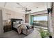 Elegant main bedroom with private balcony, ceiling fan and luxurious furnishings for a serene retreat at 4208 Lapis Ridge Ct, Las Vegas, NV 89135