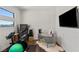 Office area featuring modern desk, stationary bike, and mounted television at 4208 Lapis Ridge Ct, Las Vegas, NV 89135
