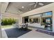 This outdoor patio features a dining area, ceiling fans, and seamless access to a spacious and brightly lit living area at 4208 Lapis Ridge Ct, Las Vegas, NV 89135