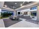 An open-air patio connects to a spacious living area, complete with comfortable seating and a stylish dining set at 4208 Lapis Ridge Ct, Las Vegas, NV 89135
