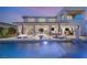 An inviting pool area at dusk, showcasing the outdoor seating and entertainment space at 4208 Lapis Ridge Ct, Las Vegas, NV 89135