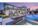 A serene backyard pool area illuminated at twilight, offering a relaxing atmosphere at 4208 Lapis Ridge Ct, Las Vegas, NV 89135